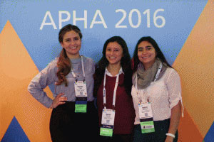 three smiling women in front of APHA 2016 logo