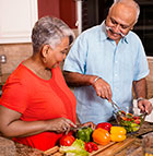 Indian couple chopping vegetables