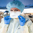 health worker in mask and gloves and surgical gown