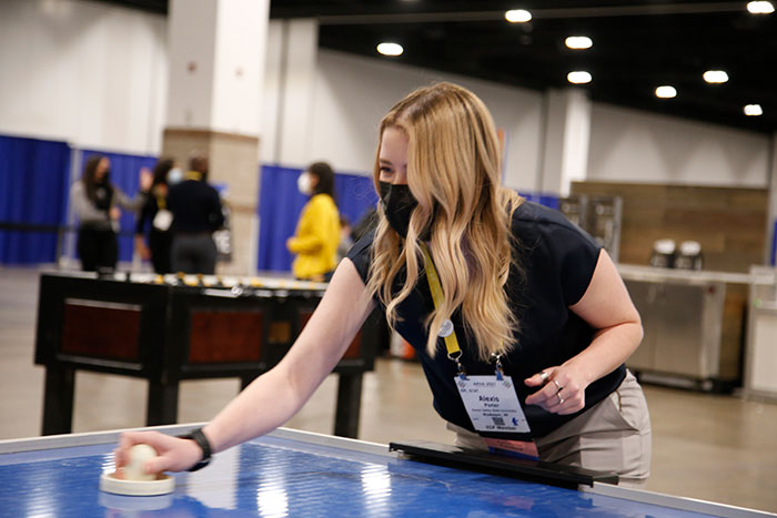 woman playing air hockey