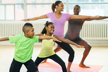 family in warrior pose