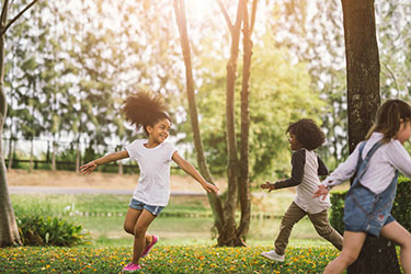 Girl playing in park with others