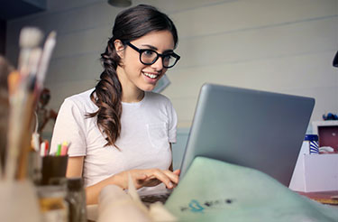 smiling young woman at laptop