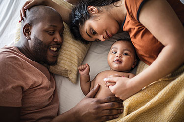 Parents with baby lying down