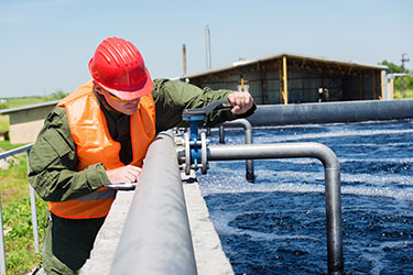 Worker adjusting water pipe