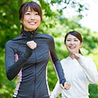 Two smiling women jogging