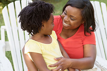 Woman smiling at child