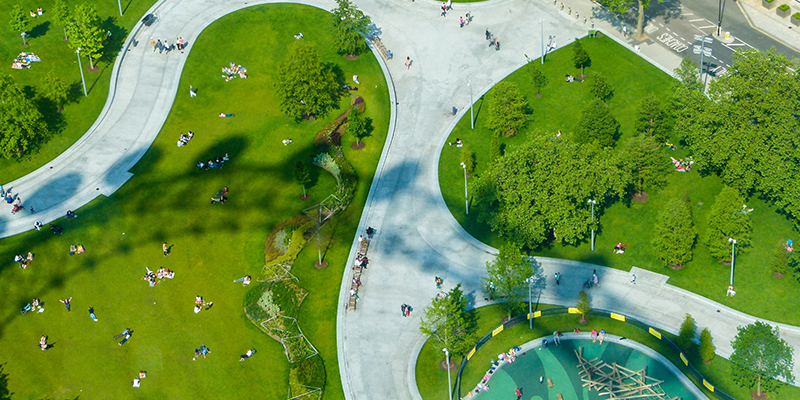 An aerial view of people enjoying a park with pathways