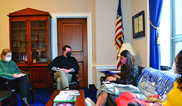 A student talks with a congressional staffer about climate policy