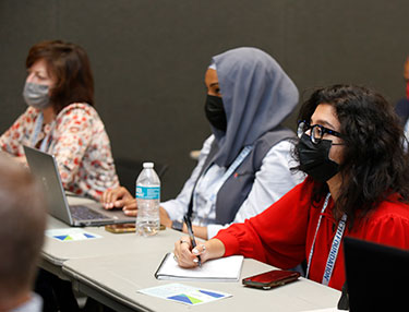 Audience members take notes during a climate change session at the 2022 APHA Annual Meeting. 