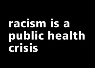 White lettering on a black background that says Racism Is a Public Health Crisis. 
