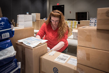 Health worker packs boxes during pandemic