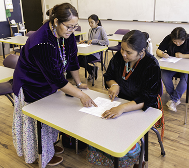 A teacher instructs a student