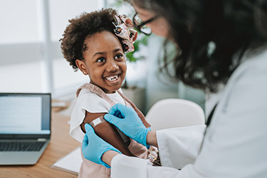 Child receives an MMR vaccination from a health professional