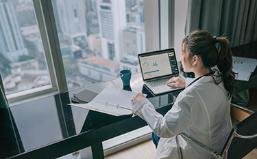 A woman works at her computer