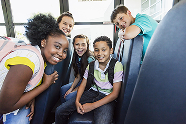 Happy middle school kids on a bus