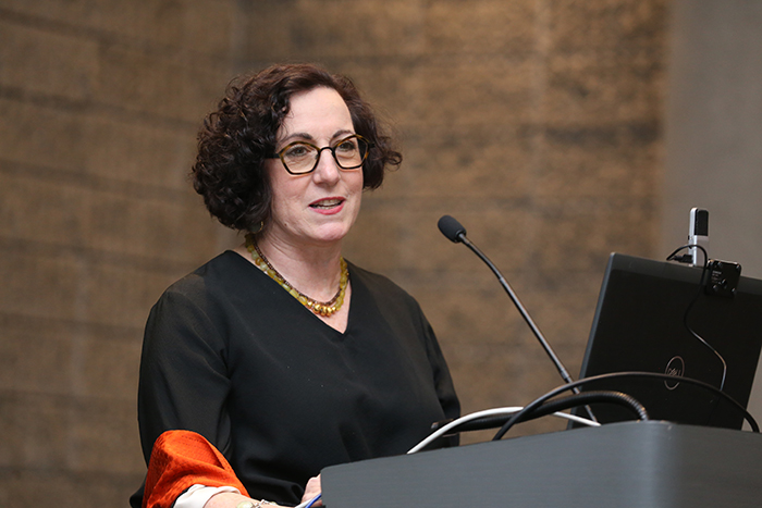 Woman speaking at lectern 