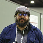 Man with beard and glasses and cap on his head