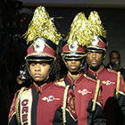 Three members of the Creekside High School Band Drumline in full band uniform 