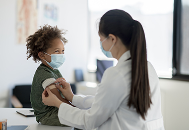 Doctor gives a child a vaccination