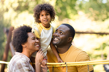 Man and woman pose with child