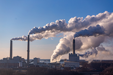 Pollution emanates from smokestacks at a factory