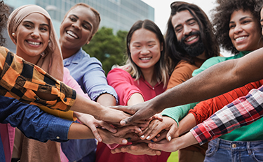 People of various races and ethnicities hold hands