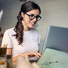smiling young woman at laptop