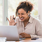Woman happy in front of computer after registering for Annual Meeting