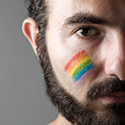 Man with rainbow colors on cheek